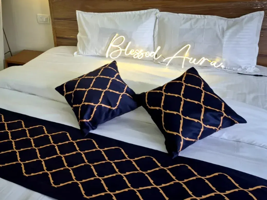 King bed with a plush eight-inch mattress dressed in white linen and navy cushions